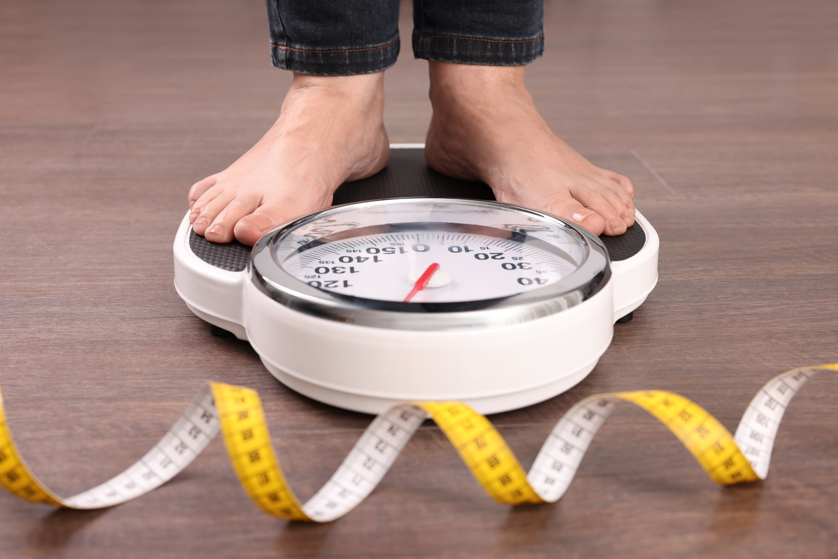 Person Standing on a Weighing Scale